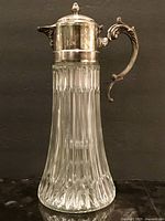 Pitcher assembled front view showing glass body and silver plated lid