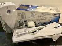 Full set showing mandoline base, accessories, manual and box