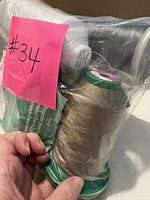 Bagged assortment of large thread cones and small spool