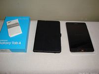 Tablet, case and box laid out on surface