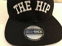 Front view showing embroidered text and visor sticker