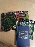 Overhead photo showing all four gardening books together on a wood surface