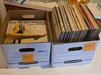 Two banker’s boxes filled with vinyl LP records