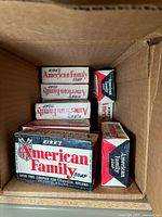 Top-down view inside partially filled box containing multiple Kirk's American Family Soap bars wrapped in original vintage paper packaging.