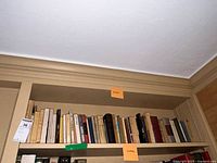 Wide shot of full book shelf with various French literature books covering multiple authors and topics.