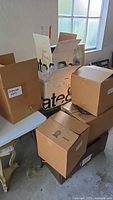 Seven cardboard boxes labeled Costume Hats and Crate & Barrel containing vintage clothing and accessories