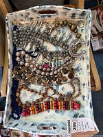 All nine necklaces displayed on painted tray