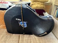 Closed molded hard shell case with bungee cord closure and Boston Symphony sticker