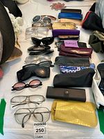 Lot layout showing multiple women's eyewear and assorted cases in various colors and styles.