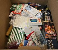 Box of assorted party candles and candle accessories in original packaging