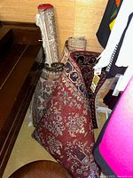 Rolled and partially unrolled rugs leaning in closet space