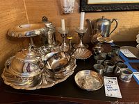 Overall group of silver-plated servingware on table