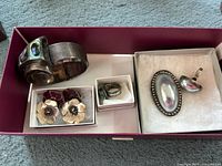 Overall display of lot showing cuff bracelet, matching abalone ring, clip-on earrings, turquoise ring, blistered pearl ring and brooch.