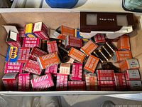 Overview photo of the stereoscopic viewer and many boxes of film strips in original packaging inside a box.