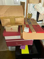 Stack of cardboard boxes containing the vintage clothing and accessories lot.