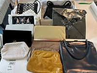 Top view of nine vintage clutch purses in various materials such as leather, satin, velvet, and beaded designs.