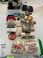 Overview photo of all vintage coin purses, compacts, pill boxes, wallets, and holders displayed on a white surface showing size and variety.