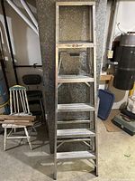 Front view of the 6-foot aluminum step ladder showing six steps and foldable design.
