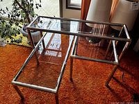 Main photo showing the 3 tables together; coffee table, end table, and console table with metal frames and glass tops.