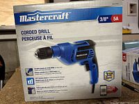 Box front of Mastercraft Corded Drill showing brand, 3/8" chuck size, 5A power rating and features.