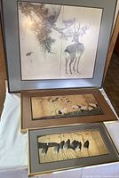 Photo showing all three framed Japanese art prints together on a white cloth.