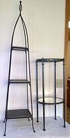 Full view of both items: a tall three-tiered iron plant stand with square slate shelves and a shorter small metal side table with circular glass and mirror shelves.