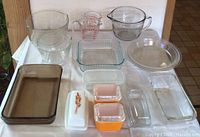 Full lot layout including mixing bowls, measuring cups, storage containers, butter dishes, pie dishes, and casserole dish