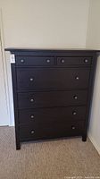 Front view of tall six-drawer dresser in blackish brown finish with round knobs
