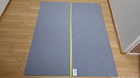 Two identical light grey carpet runners laid side by side on wooden floor, showing overall size and condition.