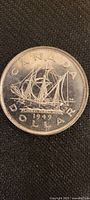 Obverse side showing ship engraving 'S.S. Coast Beaver', date 1949, and inscriptions 'CANADA DOLLAR'.