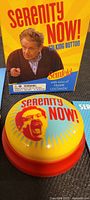 Photo of Serenity Now! talking button on black surface with box behind it showing Frank Costanza image and logos