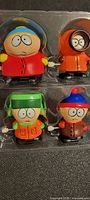 Set of four Southpark wind-up toys in plastic packaging, characters include Cartman, Kenny, Kyle, and Stan. View shows all four figures as a group.