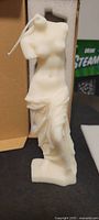 Front view of the Venus Goddess soy candle showing draped flowing skirt and torso shape
