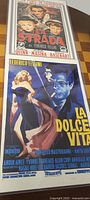 Two vintage Federico Fellini movie prints shown together. Top print: La Strada. Bottom print: La Dolce Vita.