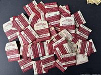 Lot showing approximately 45 vintage Electrogas watch crystal packages laid out overlapping on a black surface.