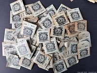 Lot of approximately 63 pieces Lentille Chevee pocket watch crystal envelopes spread out, showing vintage packaging with size markings and logos.