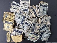 Photo showing a collection of about 33 small paper envelopes labeled 'G-S Flexo Crystals' for pocket watch faces.