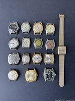 Photo showing 15 vintage men's wristwatches with various dial colors and case shapes mostly without bands