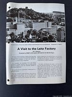 Document titled 'A Visit to the Leitz Factory' with black and white photo of the factory and introductory text about the visit.