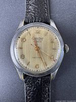 Close-up front view of the Exactus watch dial showing brand, features and dial condition.