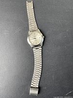 Full view of the vintage stainless steel Tissot men's watch including linked bracelet and clasp.