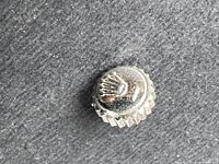 Top view of one vintage Rolex watch crown showing embossed crown logo