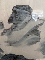 Close-up showing detailed brushwork of the rocky landscape in the watercolour painting.