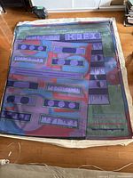 Unstretched canvas laid flat on floor showing full abstract design and condition