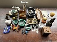 Overall view of mixed desk accessories and collectibles arranged on wooden surface