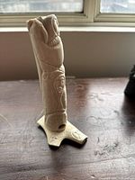 Front diagonal view of entire bone carving on stand