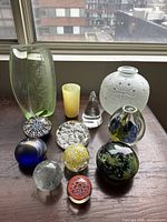 Wide view of all vases and paperweights on table