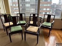 Overview of six chairs—two armchairs at front, four side chairs behind—arranged on area rug beneath window