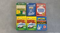 Front view of 6 vintage baseball card boxes from mid-late 1980s and 1990s era with colorful sports branding and team themes.