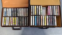 Photo showing two open cassette tape cases filled with over 70 cassette tapes. Visible artists include classic rock and pop such as R.E.M., Bruce Springsteen, Bonnie Raitt, Billy Joel, Men At Work.